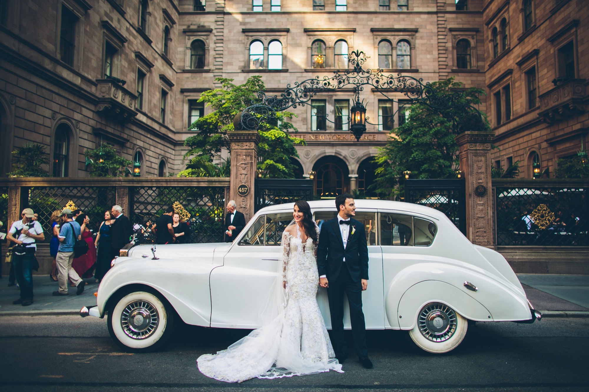 A couple with a vintage Rolls-Royce outside the Villard Mansion at the Lotte New York Palace