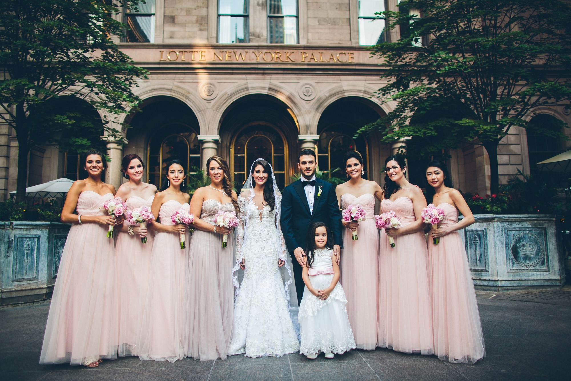 The full wedding party in the Villard Mansion courtyard