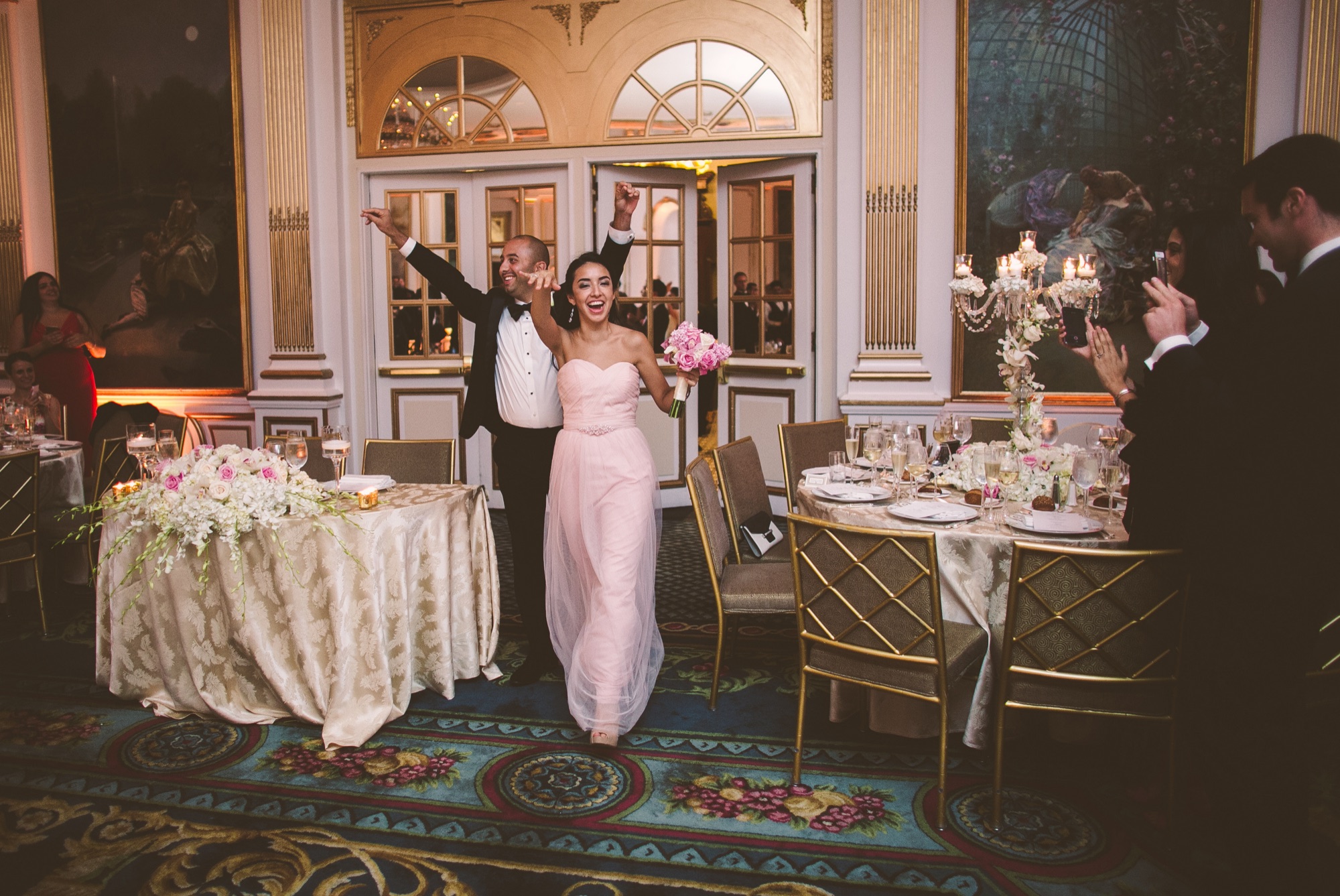 The ballroom set for dinner with its arched windows and painted panels