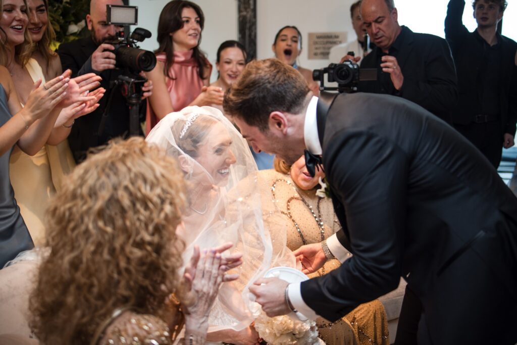 Gordon lowering the veil over Kinneret's face during the badeken