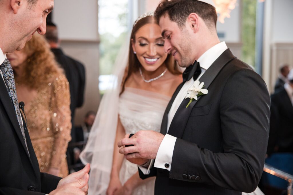 The ring going onto the bride's finger under the chuppah