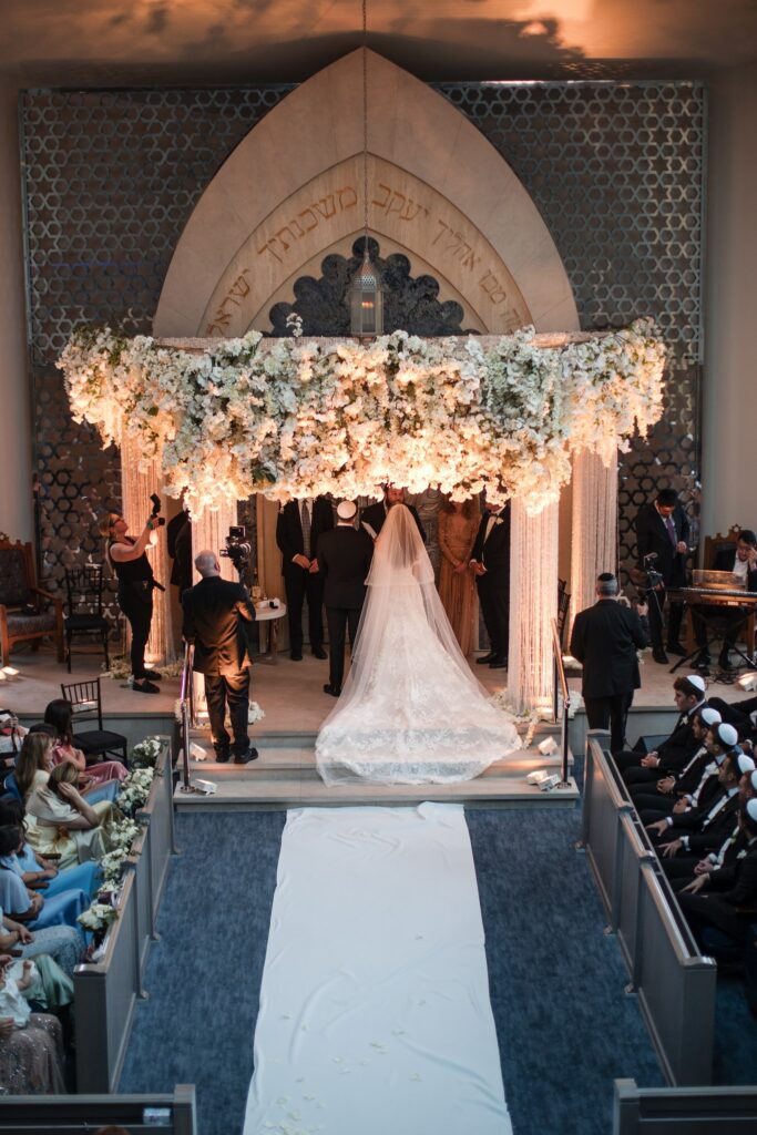 The full chuppah of white orchids and hydrangea built over the ark at Ohel Yaacob Congregation in Deal