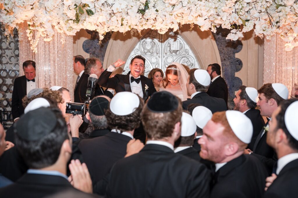 Men closing in around the groom during the recessional