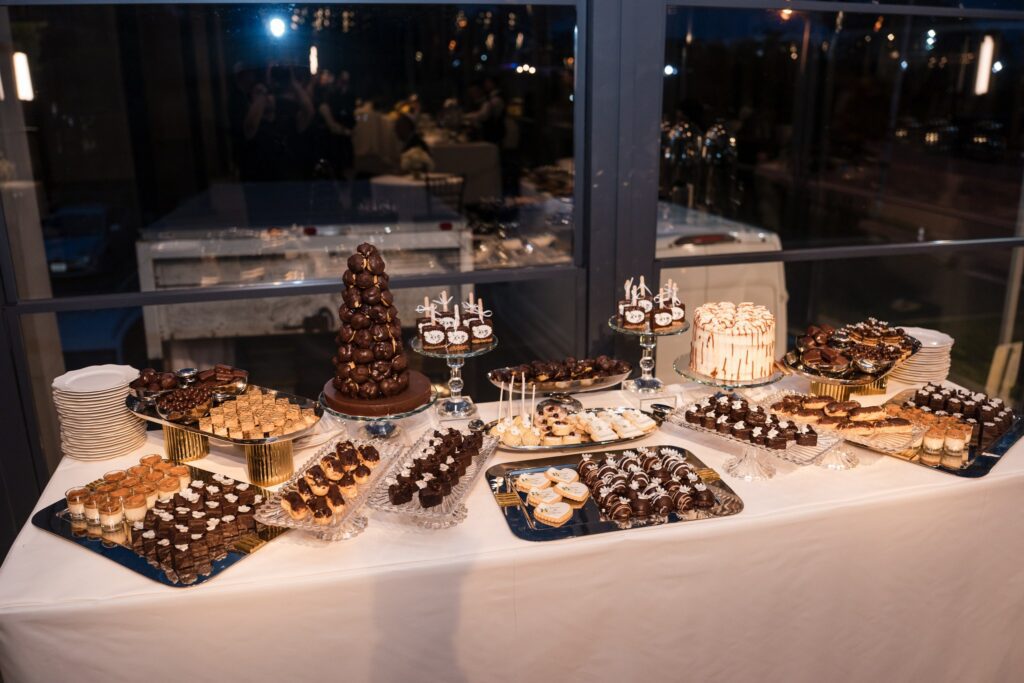 The full length of the dessert display, with baklava, maamoul, cookies and mousse cups