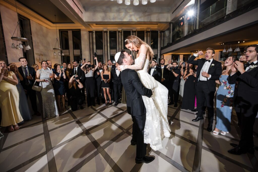 The groom lifting the bride during their first dance
