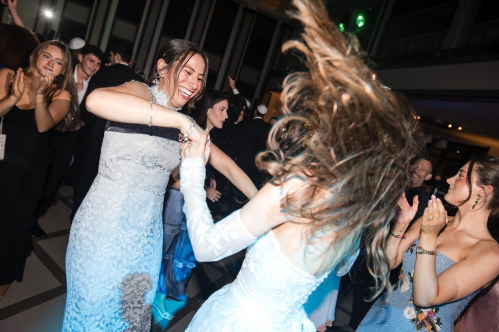 Women dancing at the reception, hair and skirts in motion