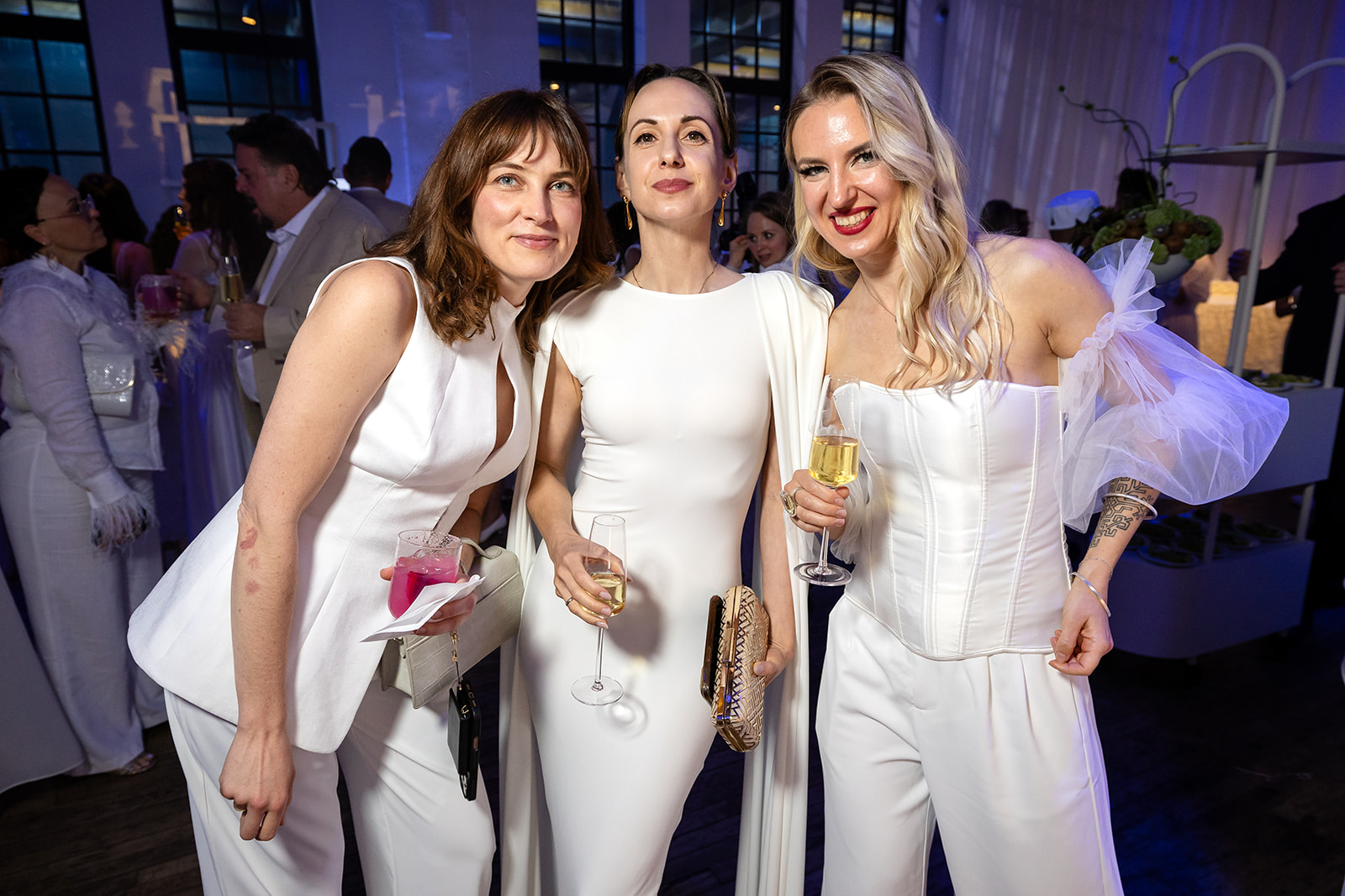 Three guests celebrating at the WIPA New York White Party
