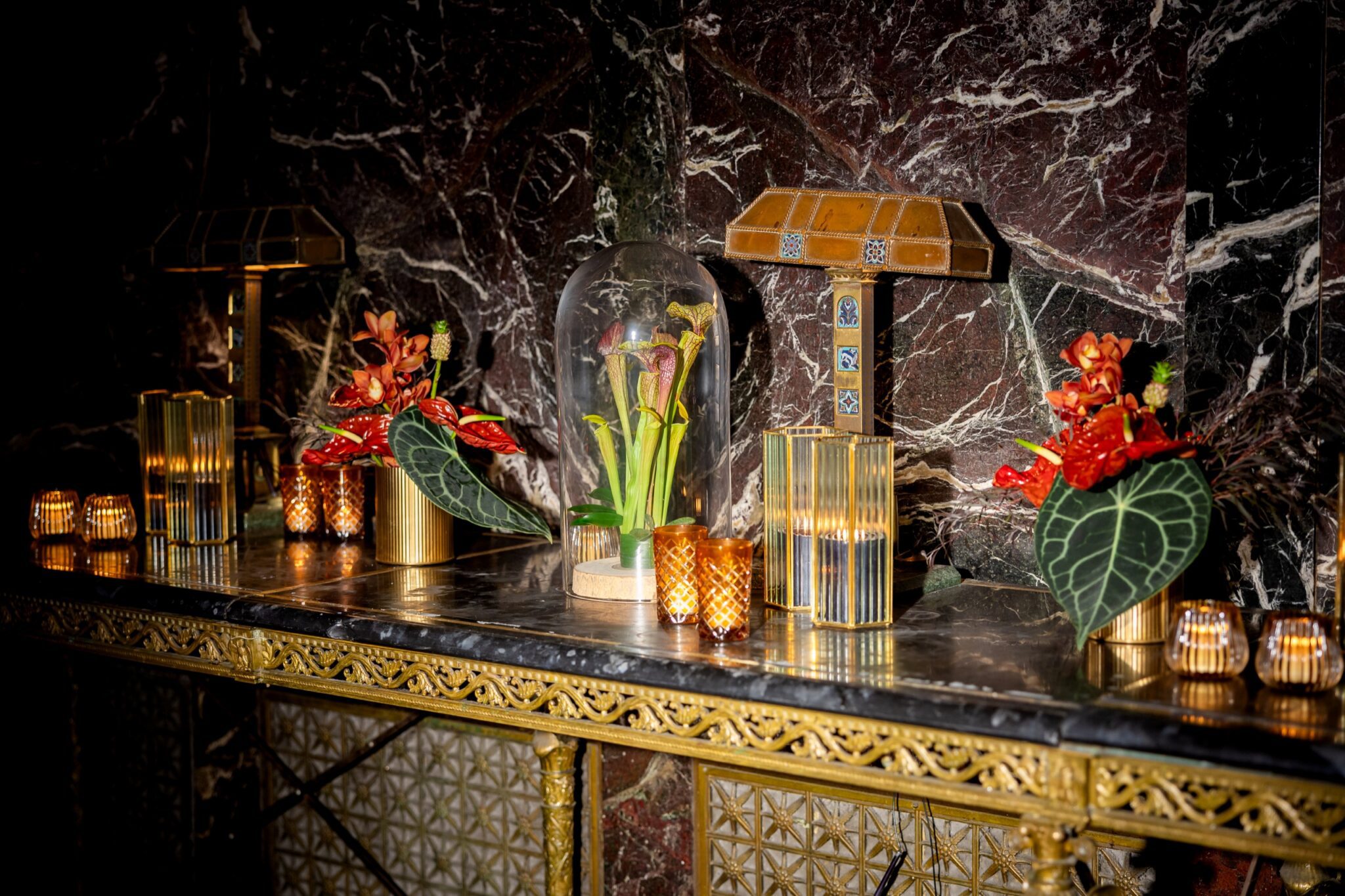 Marble console styled with lamps, candles, and flowers at Cipriani 42nd Street
