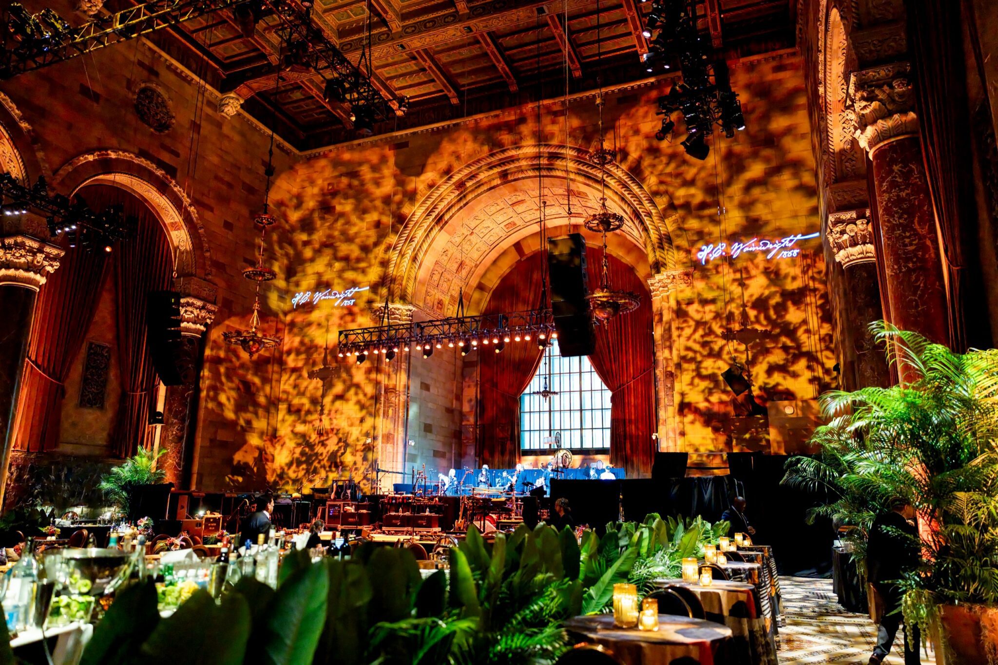 H.C. Wainwright gala stage framed by tropical greenery inside Cipriani 42nd Street