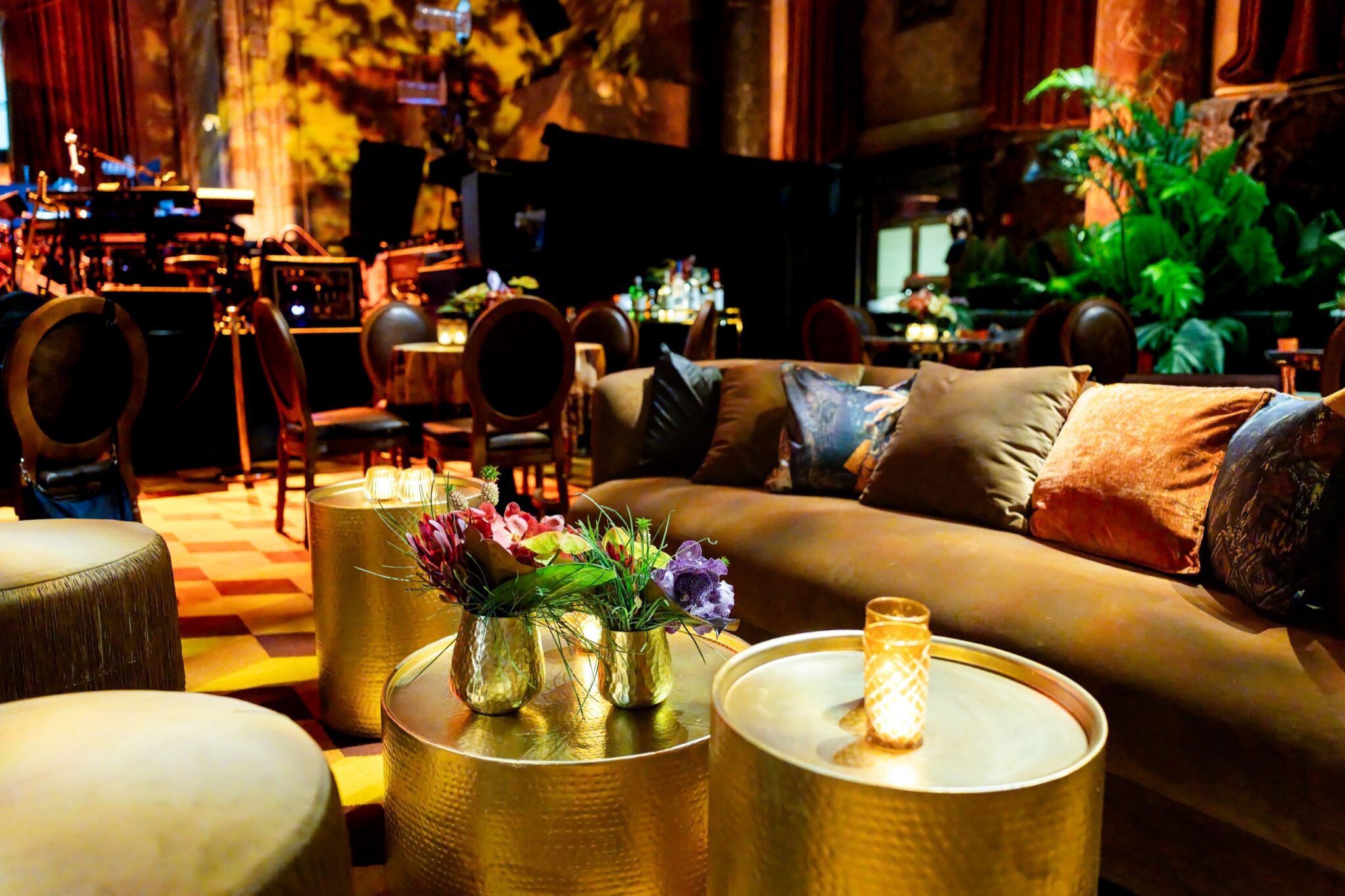 Curved lounge seating and gold cocktail tables inside Cipriani 42nd Street