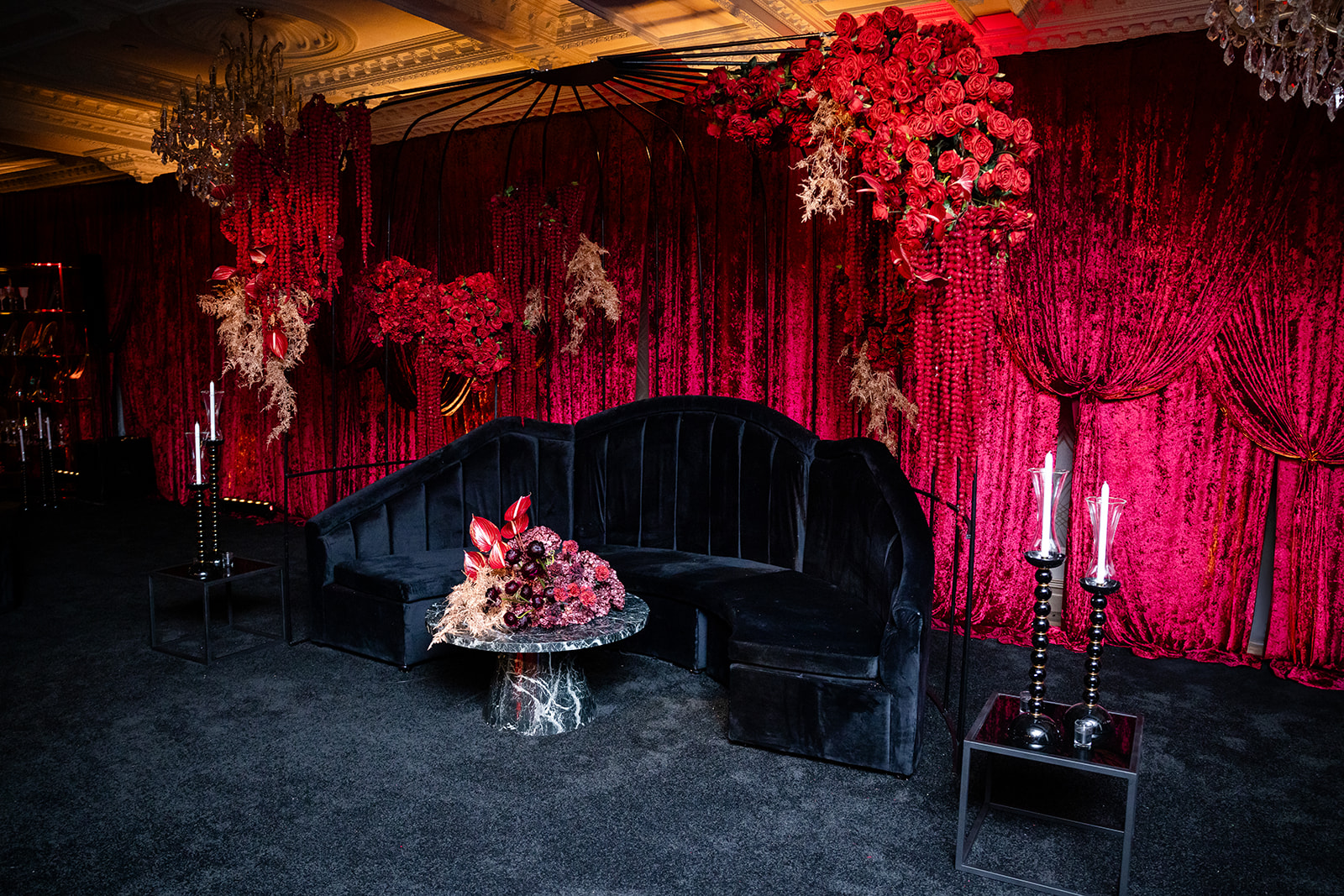 Crimson lounge with black furniture at the Highstyle Rentals gala