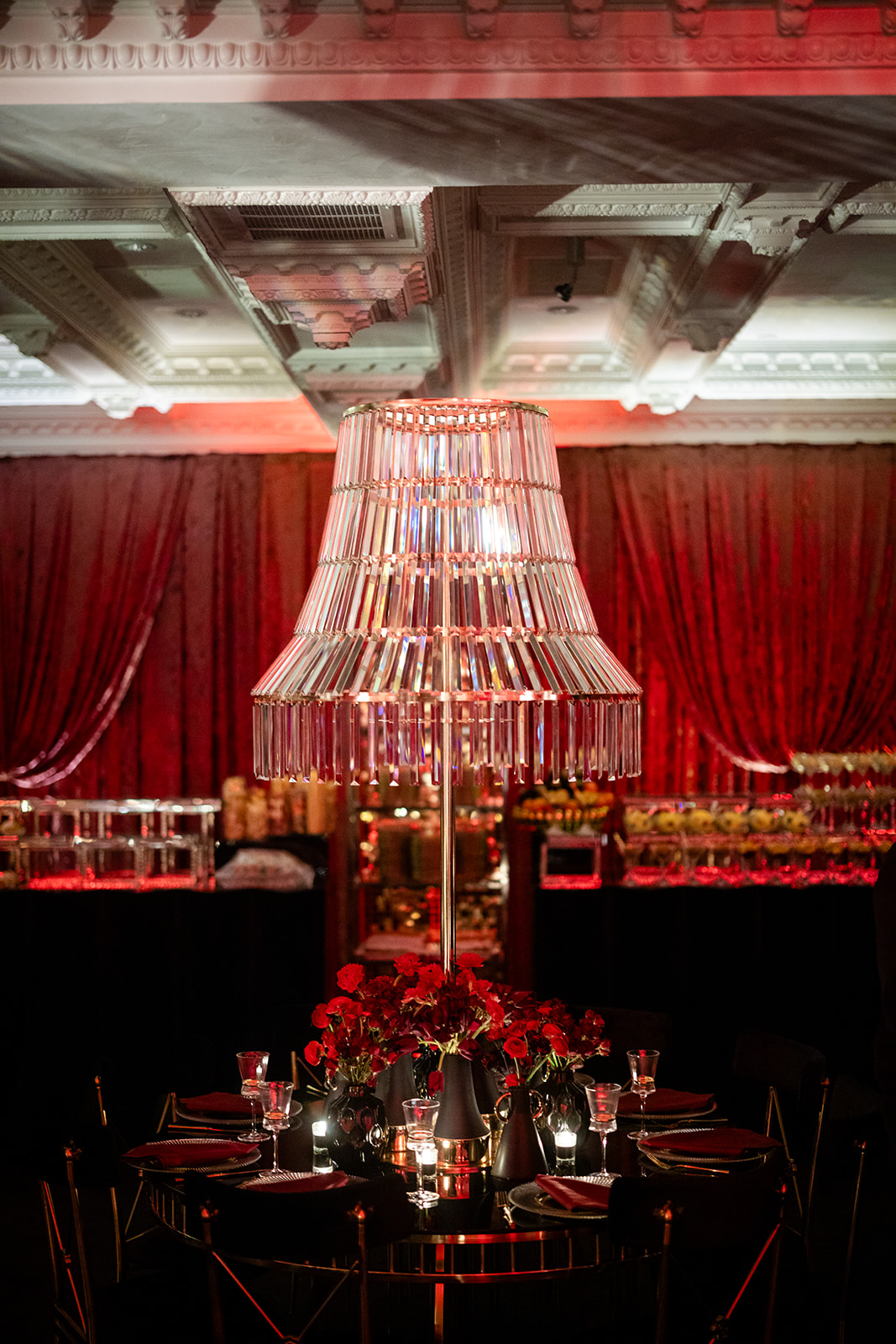 Crystal chandelier above the crimson Highstyle gala room