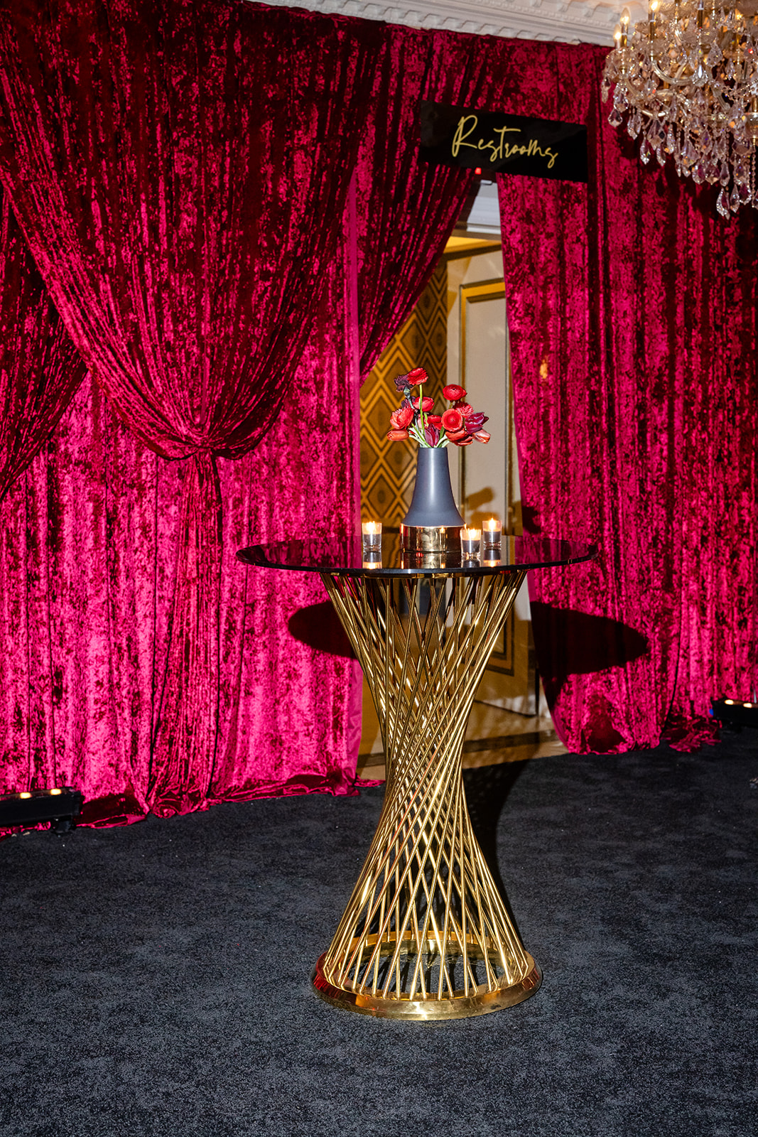 Gold cocktail table against crimson draping at the Highstyle gala