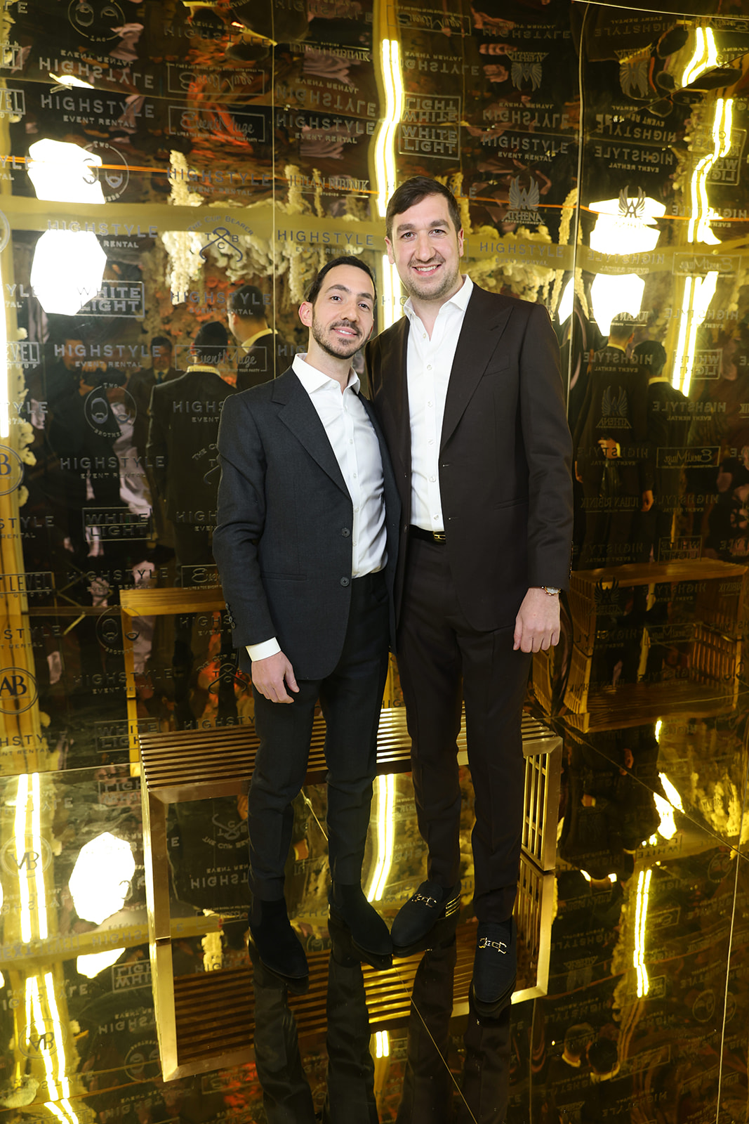 Two guests photographed at the mirrored Highstyle gala arrival installation