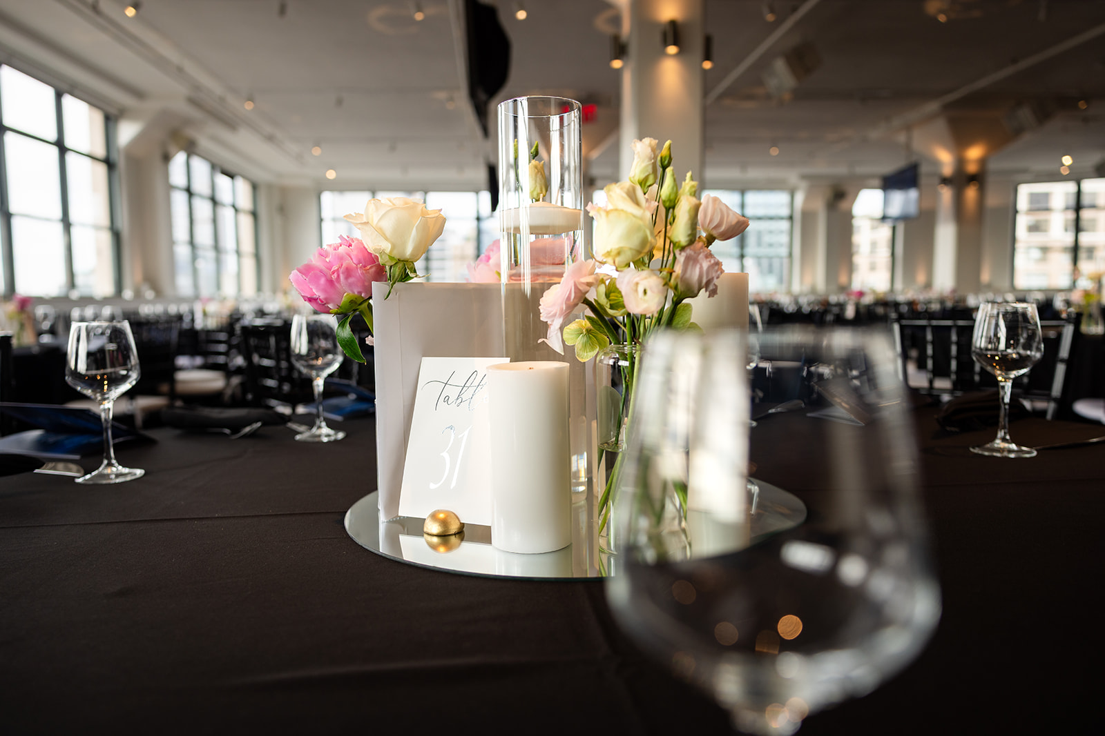Pink and ivory floral centerpiece with candles at Tribeca 360