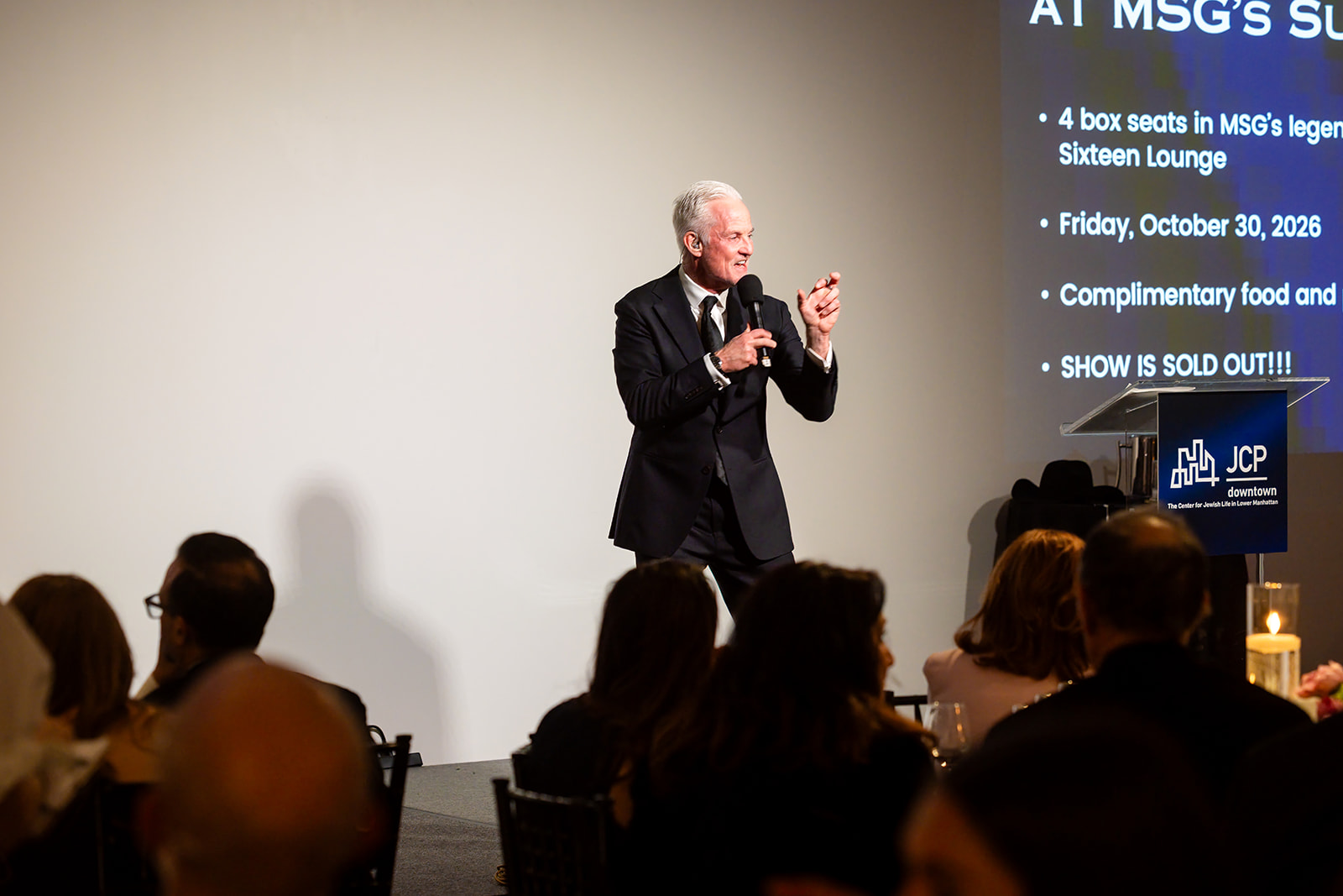 Auctioneer presenting a live auction lot at the JCP benefit