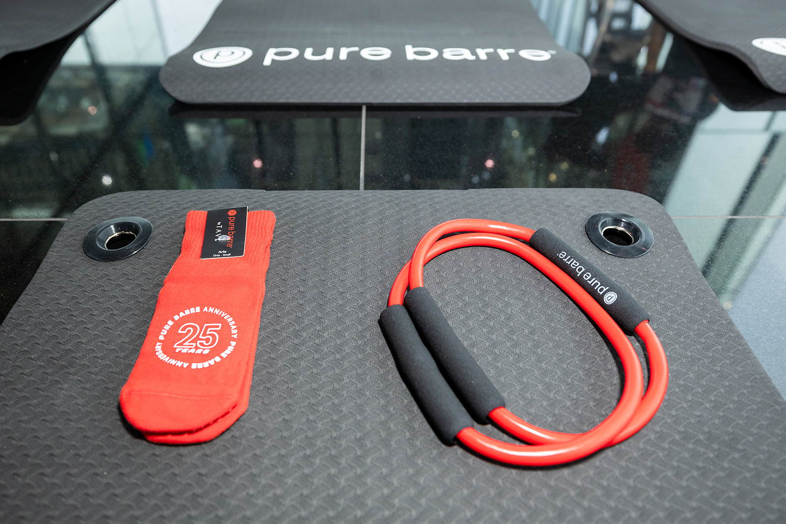 Pure Barre anniversary mat and resistance equipment prepared for class