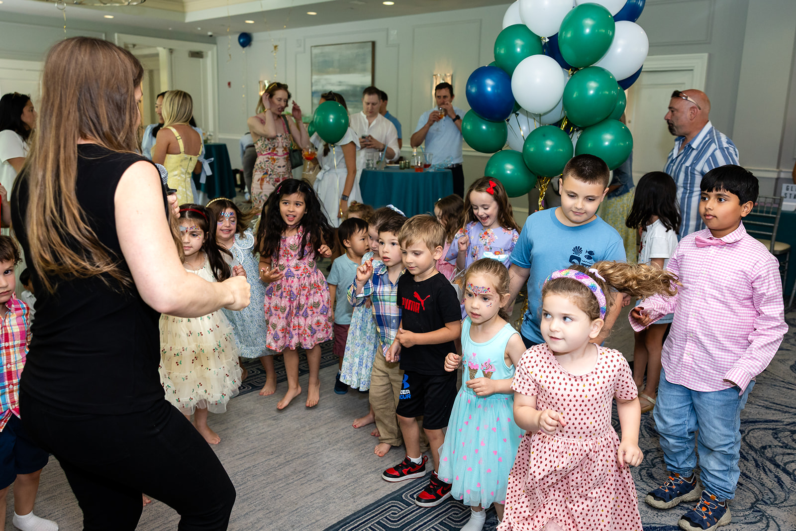Children gathered for entertainment at a first birthday party